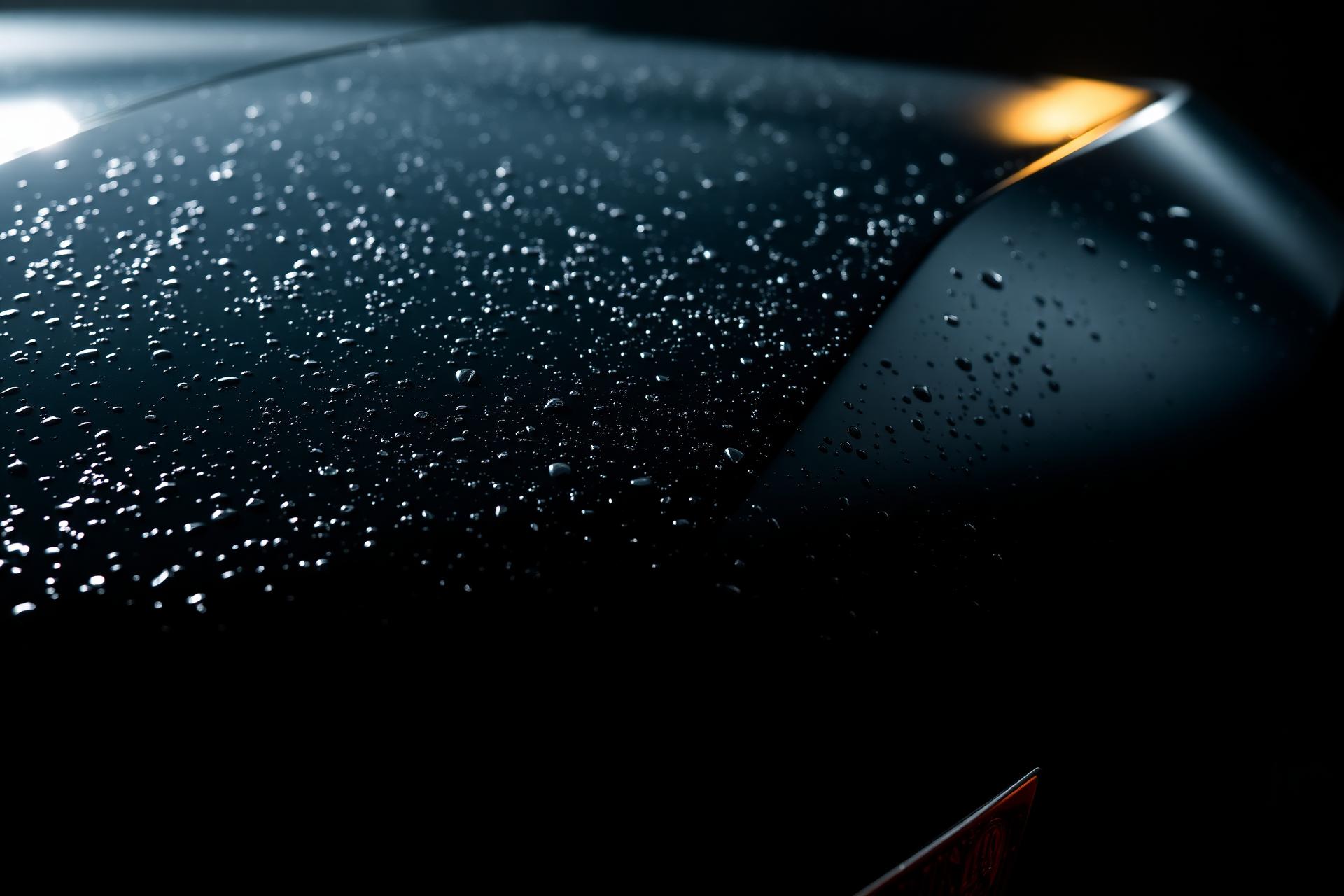Water beading on a freshly waxed black car